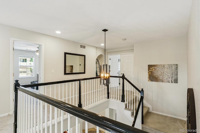 hallway with an upstairs landing, carpet flooring, baseboards, and recessed lighting