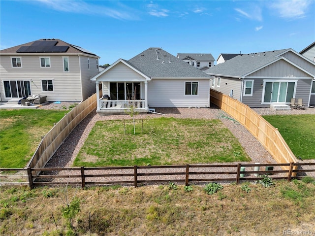 back of house featuring a lawn