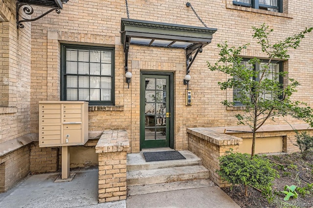 entrance to property featuring brick siding