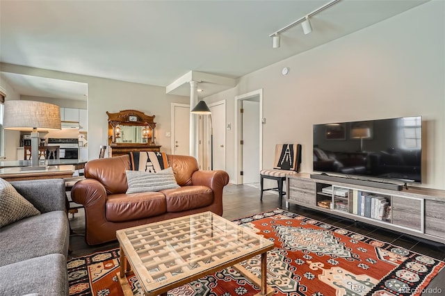 living room with decorative columns and track lighting