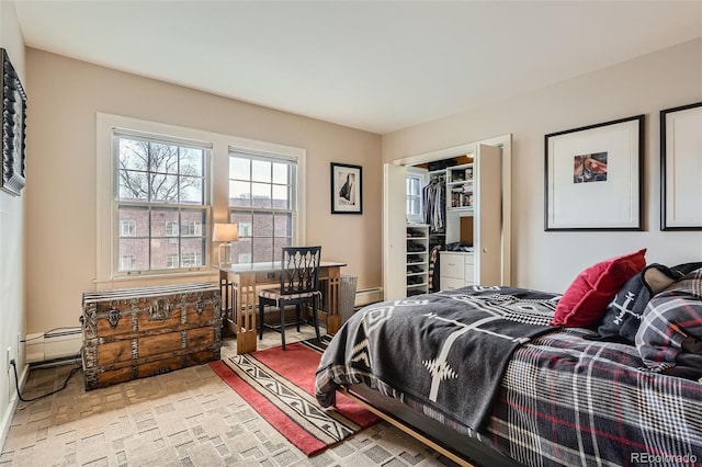 bedroom with a closet, brick floor, and a baseboard radiator