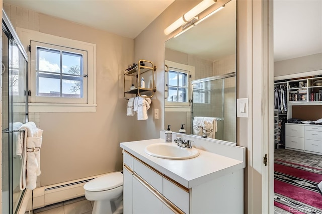 full bath featuring vanity, toilet, tile patterned floors, a shower stall, and a spacious closet