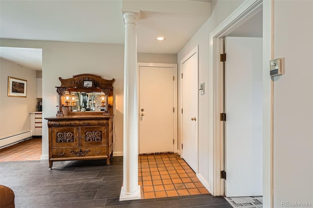 hall featuring ornate columns, recessed lighting, a baseboard heating unit, and wood finished floors