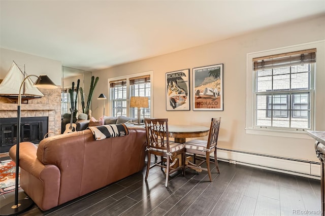living area featuring a tile fireplace and dark wood-type flooring