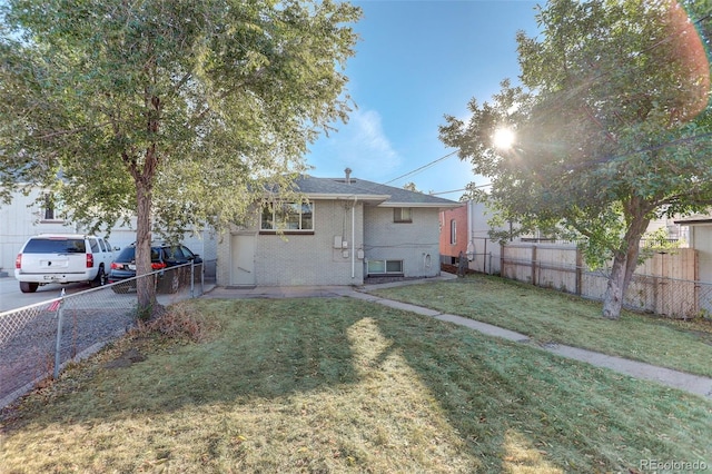 rear view of house with a yard