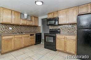 kitchen with light brown cabinetry, tasteful backsplash, black appliances, and light tile patterned flooring