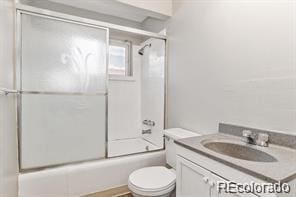 2275 S Cherokee St, Denver, CO 80223 - full bathroom featuring toilet, bath / shower combo with glass door, and vanity