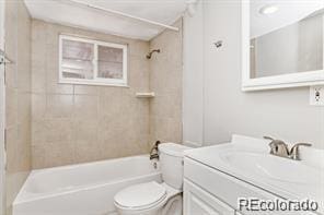 full bathroom with vanity, toilet, and tiled shower / bath combo