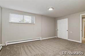 interior space with carpet and a baseboard radiator