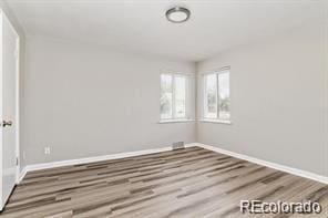 2275 S Cherokee St, Denver, CO 80223 - spare room with baseboards and wood finished floors