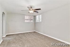 2275 S Cherokee St, Denver, CO 80223 - carpeted spare room with baseboards, ceiling fan, and arched walkways