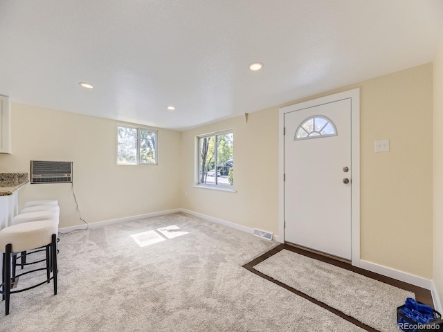 entryway with light colored carpet