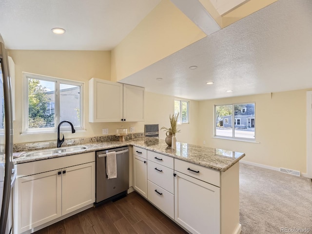 kitchen featuring light stone counters, sink, lofted ceiling, kitchen peninsula, and stainless steel dishwasher