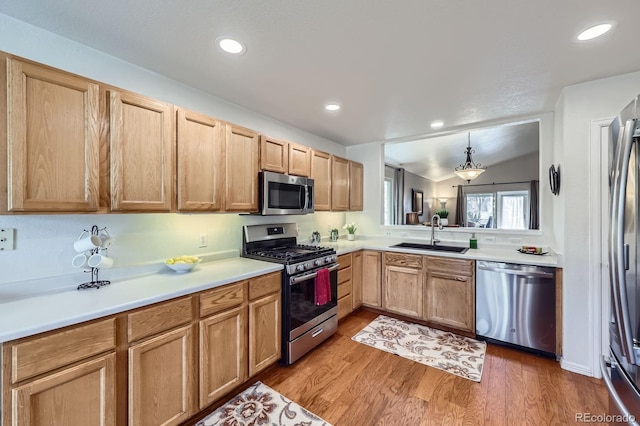 2556 E 131st Pl, Thornton, CO 80241 - kitchen featuring stainless steel appliances, a sink, light wood finished floors, light countertops, and recessed lighting