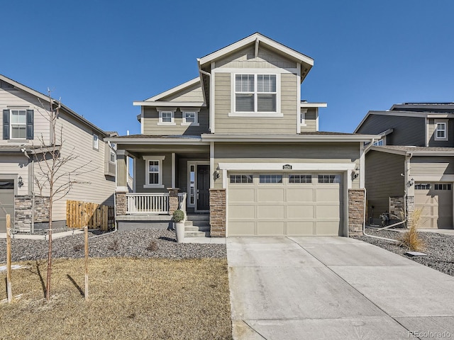 craftsman inspired home featuring a porch, stone siding, driveway, and an attached garage