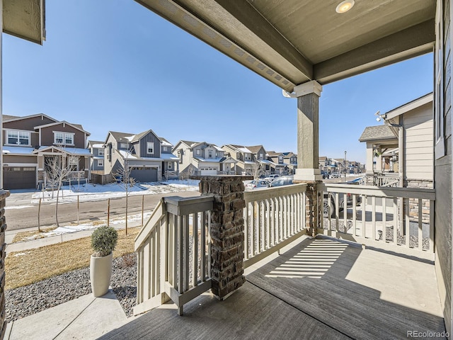 deck featuring covered porch and a residential view