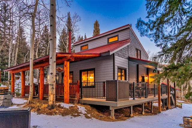 2150 Michigan Hill Rd, Jefferson, CO 80456 - snow covered rear of property featuring a porch and metal roof