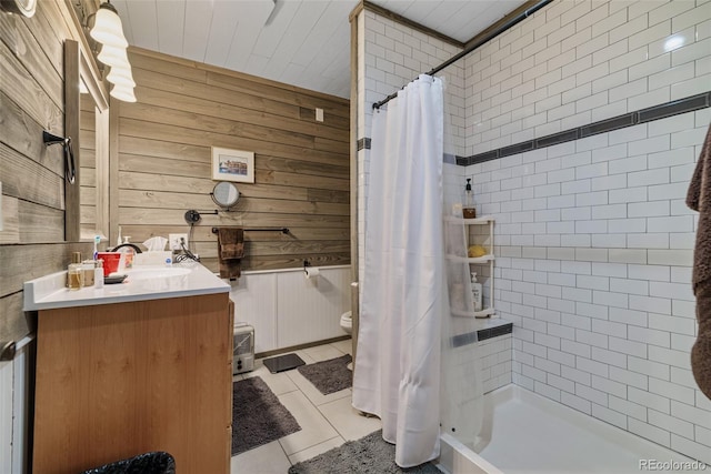 2150 Michigan Hill Rd, Jefferson, CO 80456 - bathroom featuring vanity, toilet, tiled shower, wooden walls, and tile patterned flooring