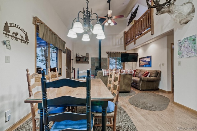 2150 Michigan Hill Rd, Jefferson, CO 80456 - dining room with wood finished floors, a chandelier, baseboards, and ceiling fan