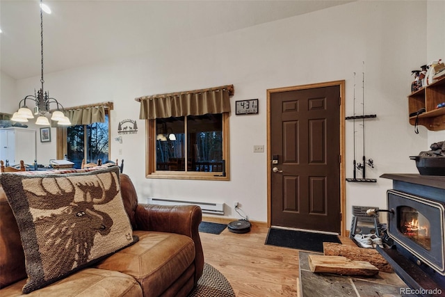 2150 Michigan Hill Rd, Jefferson, CO 80456 - living room with a baseboard radiator, wood finished floors, a chandelier, and vaulted ceiling