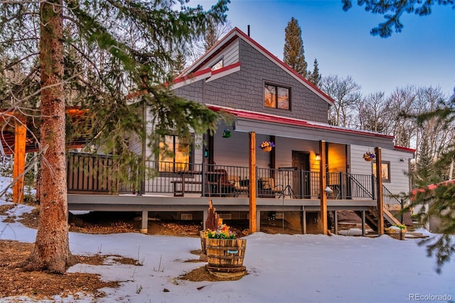 2150 Michigan Hill Rd, Jefferson, CO 80456 - snow covered house featuring stairway and covered porch