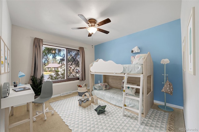 carpeted bedroom featuring visible vents, baseboards, and ceiling fan