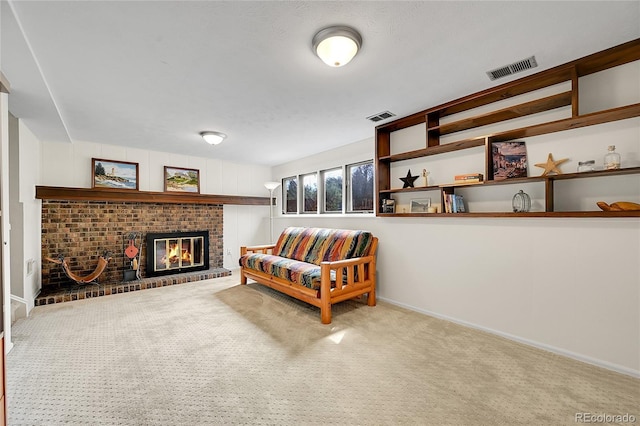 sitting room featuring baseboards, carpet flooring, a fireplace, and visible vents