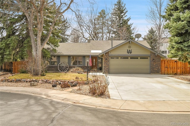 ranch-style home featuring concrete driveway, brick siding, a garage, fence, and a shingled roof