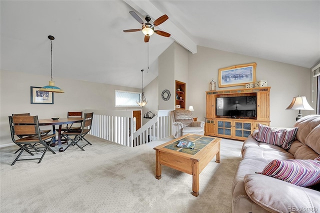 living area featuring a ceiling fan, vaulted ceiling with beams, and carpet