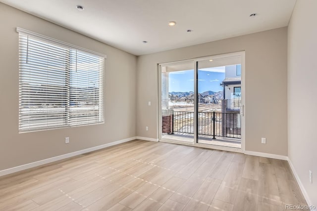 9629 Browns Peak Cir, Littleton, CO 80125 - spare room with healthy amount of natural light, baseboards, and light wood finished floors