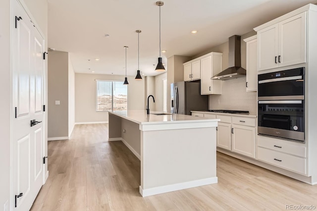 9629 Browns Peak Cir, Littleton, CO 80125 - kitchen with wall chimney range hood, double wall oven, a sink, stainless steel refrigerator with ice dispenser, and stovetop