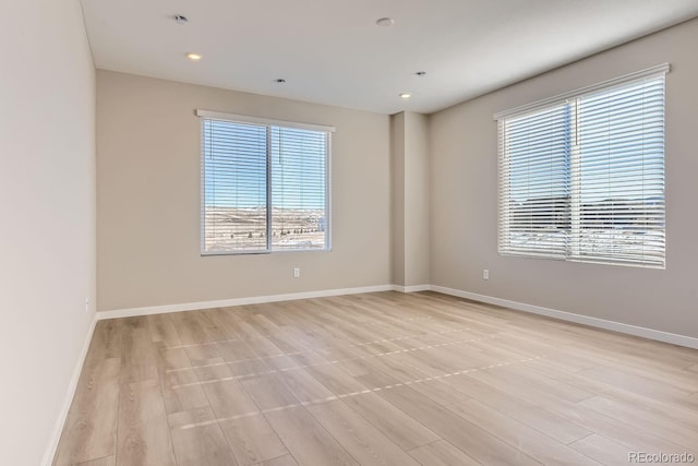 9629 Browns Peak Cir, Littleton, CO 80125 - empty room featuring healthy amount of natural light, baseboards, light wood-style floors, and recessed lighting