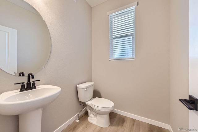 9629 Browns Peak Cir, Littleton, CO 80125 - half bath with baseboards, wood finished floors, and toilet