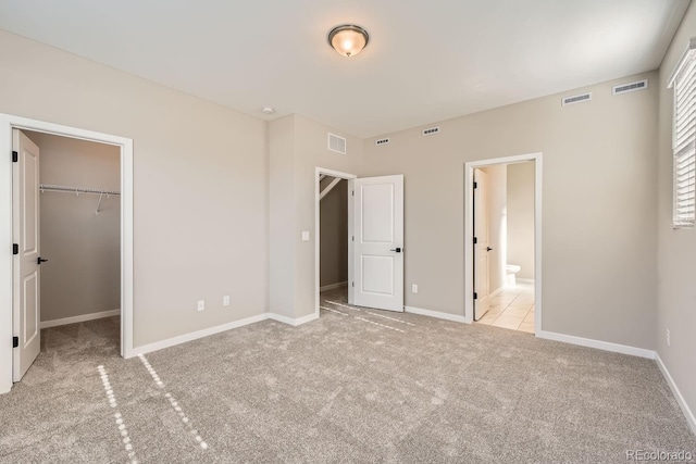 9629 Browns Peak Cir, Littleton, CO 80125 - unfurnished bedroom featuring carpet flooring, a spacious closet, baseboards, and connected bathroom