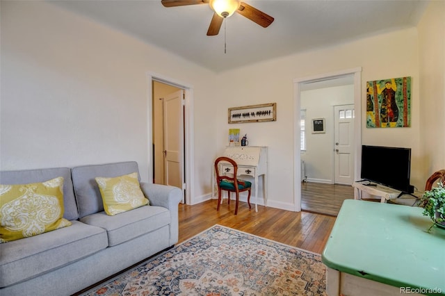 living room featuring light hardwood / wood-style flooring and ceiling fan