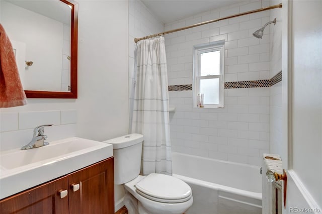 bathroom featuring vanity, toilet, radiator heating unit, and tasteful backsplash