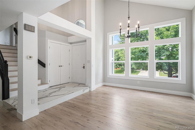19334 E Prentice Pl, Centennial, CO 80015 - entryway with a chandelier, stairs, wood finished floors, and high vaulted ceiling