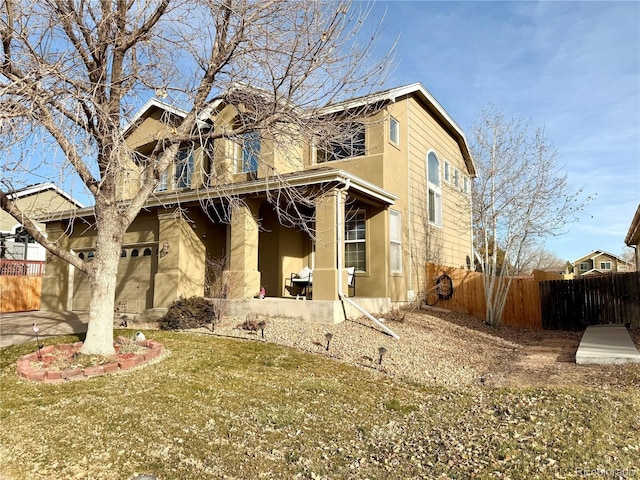 view of front of house featuring fence and stucco siding