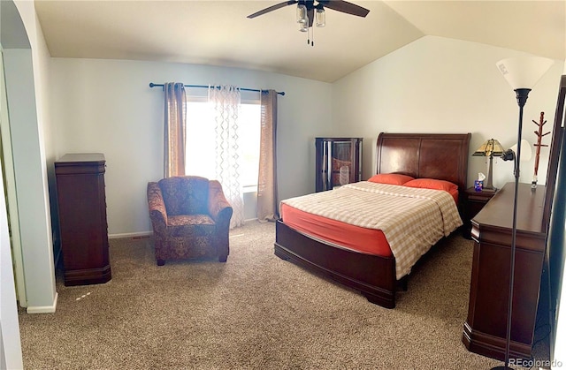 carpeted bedroom featuring vaulted ceiling, baseboards, and ceiling fan