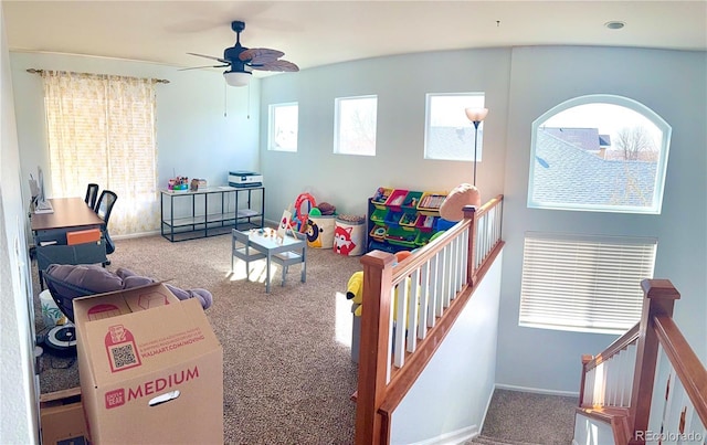 rec room featuring carpet floors, ceiling fan, and baseboards