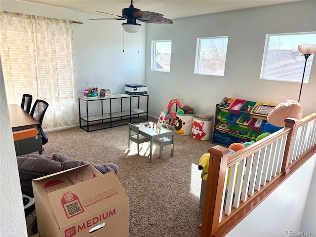 playroom featuring a ceiling fan, carpet flooring, and baseboards