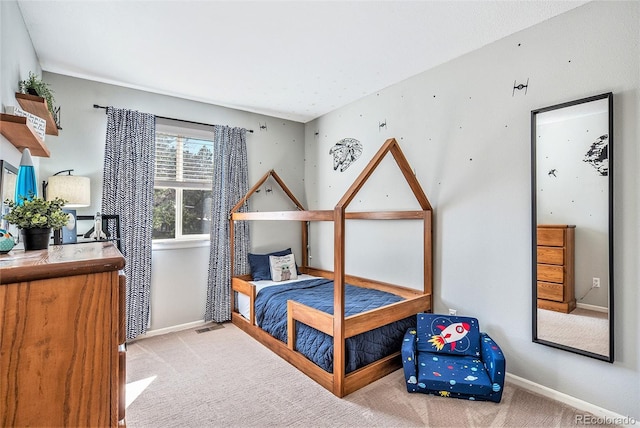 bedroom featuring visible vents, baseboards, and carpet