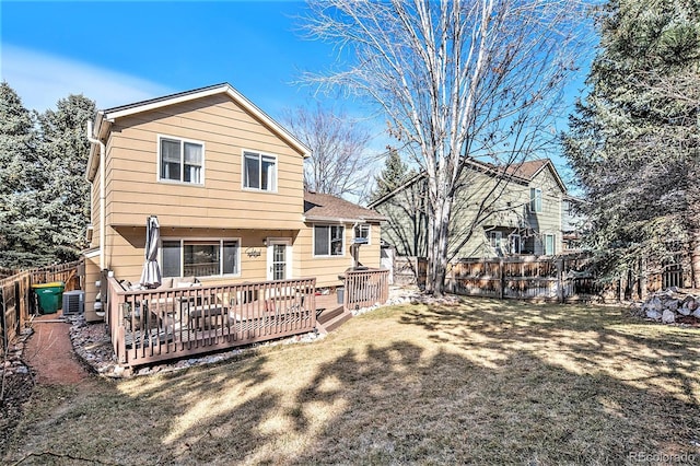 rear view of house featuring a deck, central air condition unit, a yard, and a fenced backyard