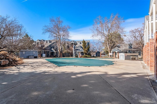 community pool featuring a patio area and fence