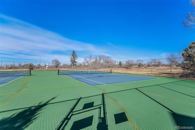 view of tennis court with fence