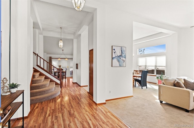 entrance foyer featuring a towering ceiling and hardwood / wood-style floors