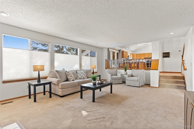 carpeted living room featuring a textured ceiling