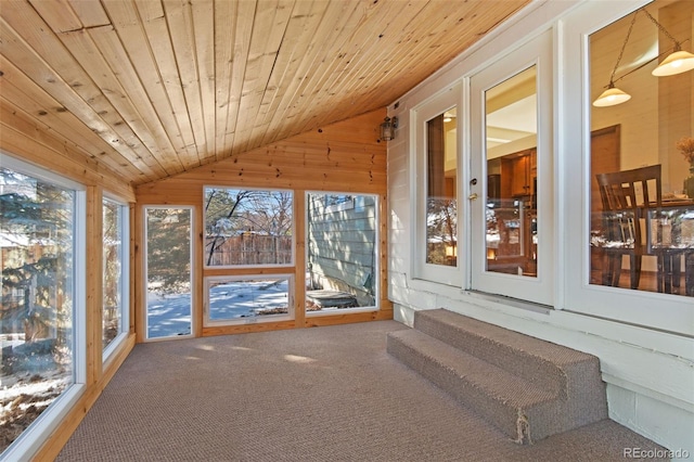 unfurnished sunroom with vaulted ceiling, wooden ceiling, and a wealth of natural light