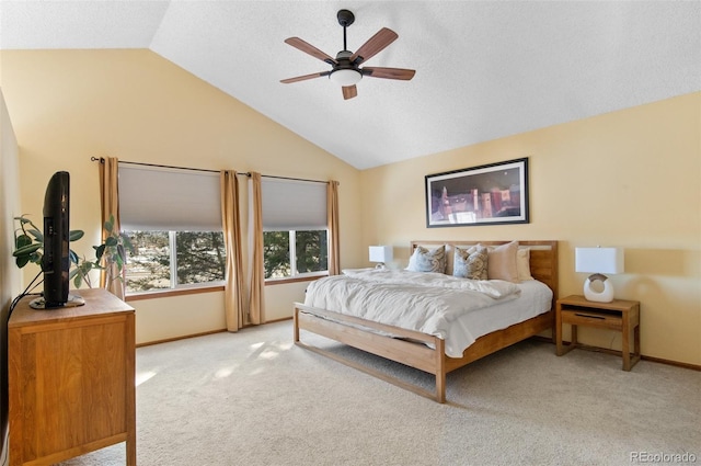 carpeted bedroom with ceiling fan and vaulted ceiling