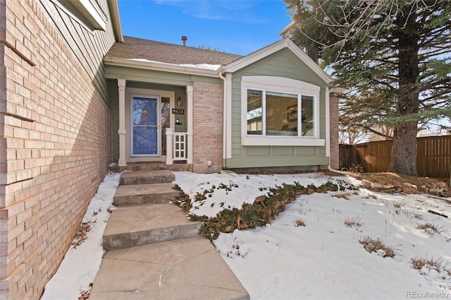 view of snow covered property entrance